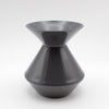 The Zalto Crystal Wine Tasting Spittoon - Dark Grey / Small by Zalto features a sleek, glossy finish with a wide flared top and bottom connected by a narrow center, shown against a plain white background.