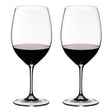 Two wine glasses filled with red wine on a white background