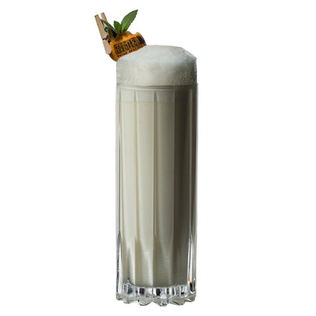 A tall, paneled Riedel Bar Drink Specific Highball Tumbler - Set of 2 - 6417/03 filled with a creamy white cocktail topped with foam and garnished with a mint sprig and an orange slice secured by a wooden clothespin.