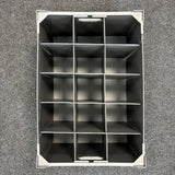 Top-down view of an empty Wineware USED - GREAT CONDITION Wine Glass Storage Box, featuring fifteen rectangular compartments arranged in a 3 by 5 grid, placed on a textured gray carpet. The dividers keep glassware separated, making this stackable 240mm high organizer ideal for safely storing and organizing delicate wine glasses.