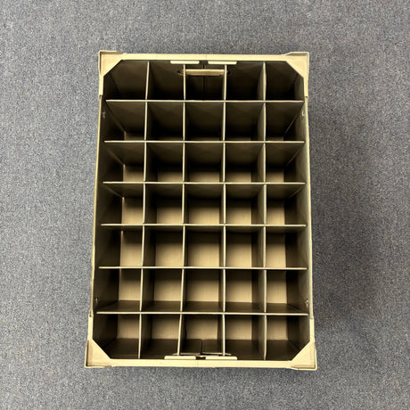 A top-down view of the USED - GREAT CONDITION Wineware Wine Glass Storage Box (190mm high, 35 cells) with compartments for organizing items, placed on a gray carpeted floor.