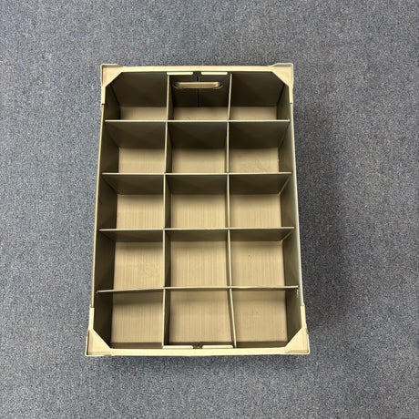 A USED - GREAT CONDITION Wineware Wine Glass Storage Box (140mm High, 15 Cells) is placed on a gray carpeted floor and viewed from above.
