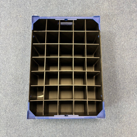 A USED - GREAT CONDITION Wineware Wine Glass Storage Box, 160mm high with 35 black dividers, sits on a gray carpeted floor, viewed from above.