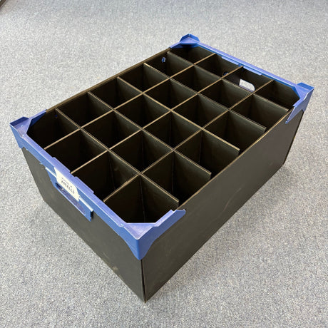 A USED - GREAT CONDITION Wineware Wine Glass Storage Box (225mm high, 24 cells) with grid divider, black finish, blue corner protectors, and side label sits on a grey carpeted floor.