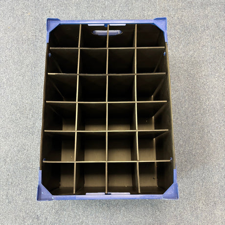 A top-down view of a USED - GREAT CONDITION Wineware Wine Glass Storage Box (225mm High, 24 Cells) with a cardboard grid divider, placed on a gray carpeted surface.