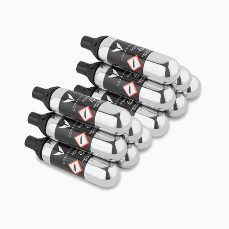 Six silver, cylindrical Coravin Pure Argon Gas Replacement Capsules with black caps arranged in a stack.