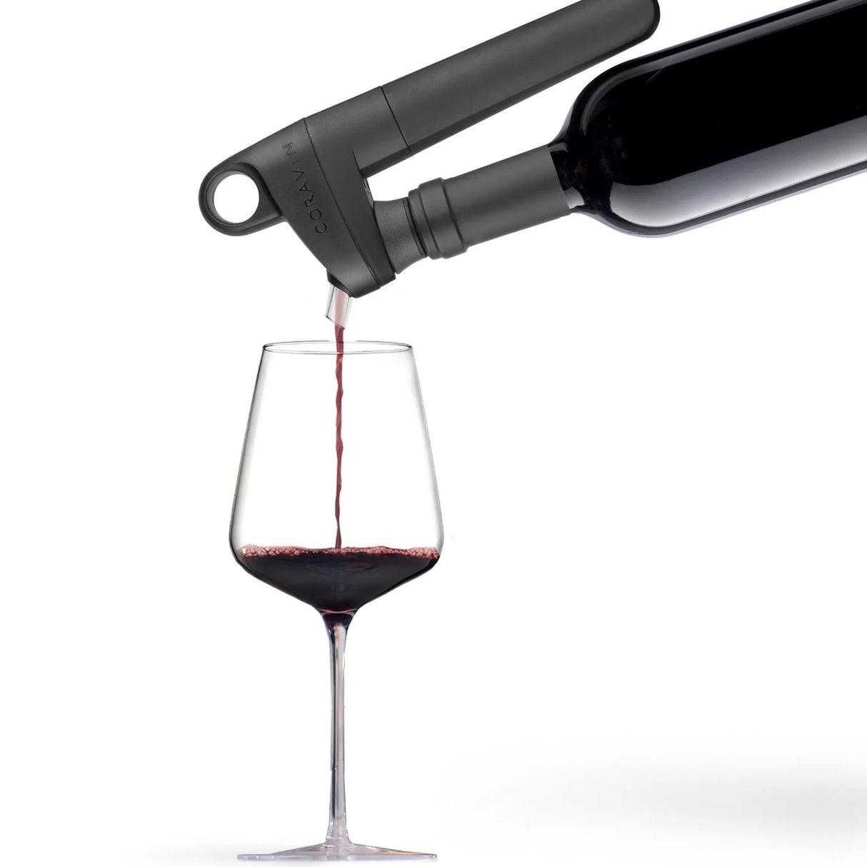 A Coravin Pivot+ Wine Preservation System - Black by Coravin attached to a wine bottle, pouring a stream of red wine into a clear glass against a white background—a must-have for anyone seeking an advanced alternative to traditional wine stoppers.