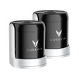 Two black and silver Coravin Sparkling Wine Stoppers from Coravin are displayed side by side, each featuring the brand’s logo on the front. The Coravin Sparkling Wine Stopper - Set of 2 is designed for use with the Sparkling Wine Preservation System to help keep your sparkling wine bottles fresh and bubbly for longer.