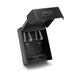A set of two Gabriel-Glas StandArt Universal Red & White Wine Glasses, crafted from lead-free crystal, displayed side by side in a sleek black box with the lid partially open. The box features the Gabriel-Glas brand name in white cursive lettering on both the inside of the lid and along the side.