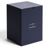 A large, dark blue rectangular box with white "Jancis Robinson x Richard Brendon" text and a white logo on the lid, ideal for presenting the 1000ml Young Wine Decanter, is displayed on a white surface.