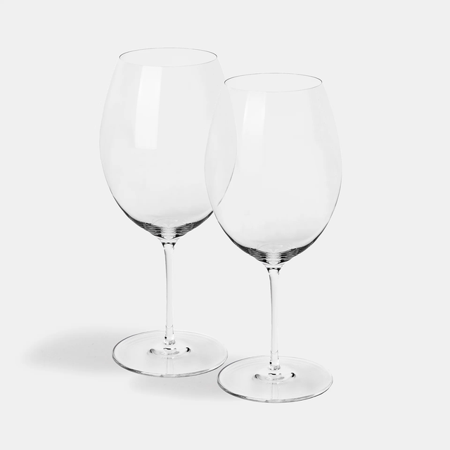 A set of two Jancis Robinson x Richard Brendon The Occasional Collection Bordeaux Wine Glasses, made from mouth-blown crystal with long stems, stand side by side on a plain white background.