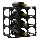 The Stakrax 12 Bottle Plastic Wine Rack in black by Stakrax is an expandable modular rack, shown on a white background, holding wine bottles with gold caps arranged horizontally.
