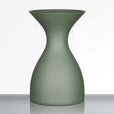 The Sydonios Small Wine Tasting Spittoon 630ml in jade green, featuring an hourglass shape and a matte finish, is displayed on a reflective surface against a plain white background.
