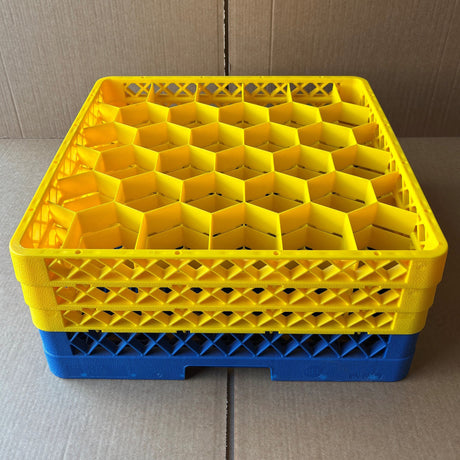 A stack of USED - GREAT CONDITION Traex Rack Master Glass Washer Trays (500x500x200mm, 30 glasses, 81mm cell) by Wineware with yellow dividers on blue bases is shown. These trays are perfect for organizing and washing glassware.
