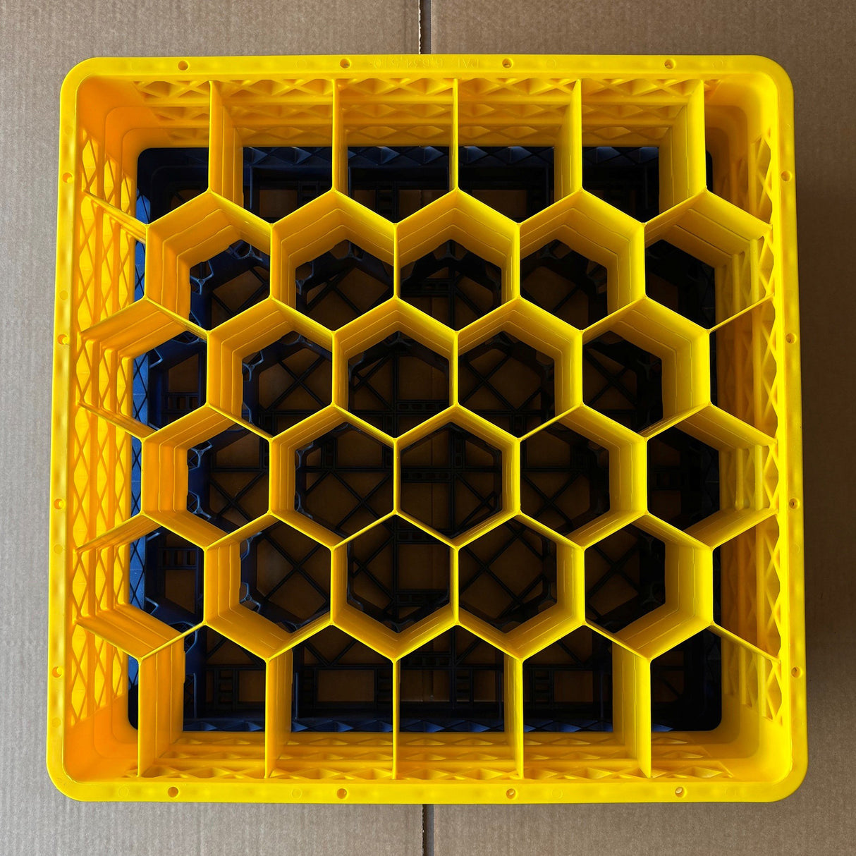 A top-down view shows a yellow Wineware USED - GREAT CONDITION Traex Rack Master Glass Washer Tray (500 x 500 x 200mm, 30 glass capacity, 81mm cells) with a honeycomb pattern, placed on cardboard.