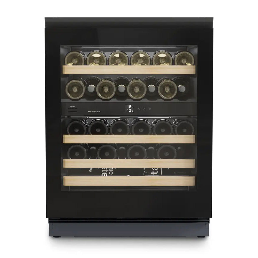 The Liebherr Vinidor UWgb 3632 is a glass-fronted, undercounter wine cabinet holding 32 bottles on four wooden shelves, with two temperature zones, a black frame, and an interior digital display.
