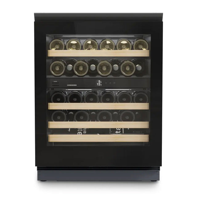 The Liebherr Vinidor UWgb 3632 is a glass-fronted, undercounter wine cabinet holding 32 bottles on four wooden shelves, with two temperature zones, a black frame, and an interior digital display.